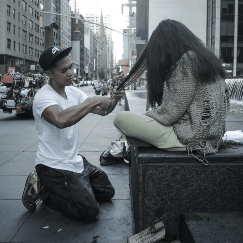 Mark Bustos cutting long hair for men in the streets of New York City