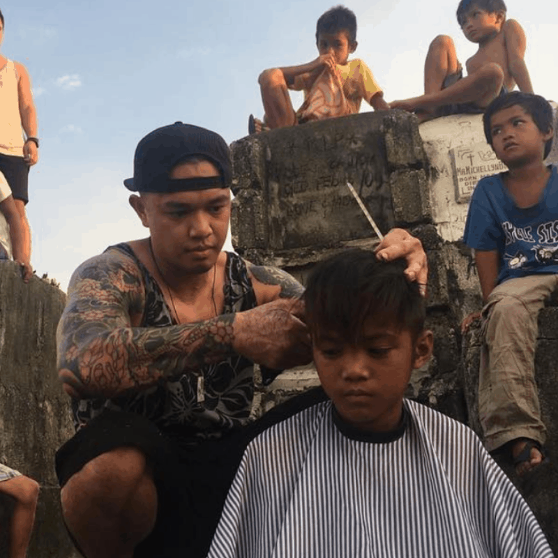 Mark Bustos cutting hair for the homeless in the Phillippines